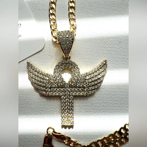Cuban link chain with ansata cross pendant and wings polished in zirconia.